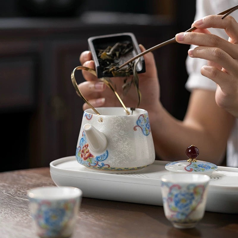 Delicate teapot and teacups